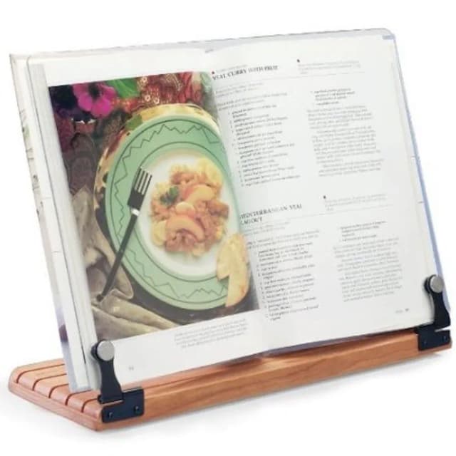 A cookbook holder holding open a large cookbook